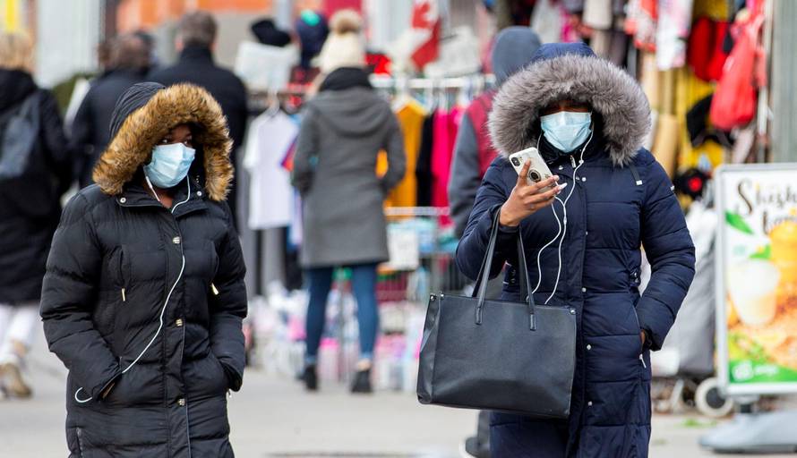 Pedestrians walk in the Chinatown district of downtown Toronto