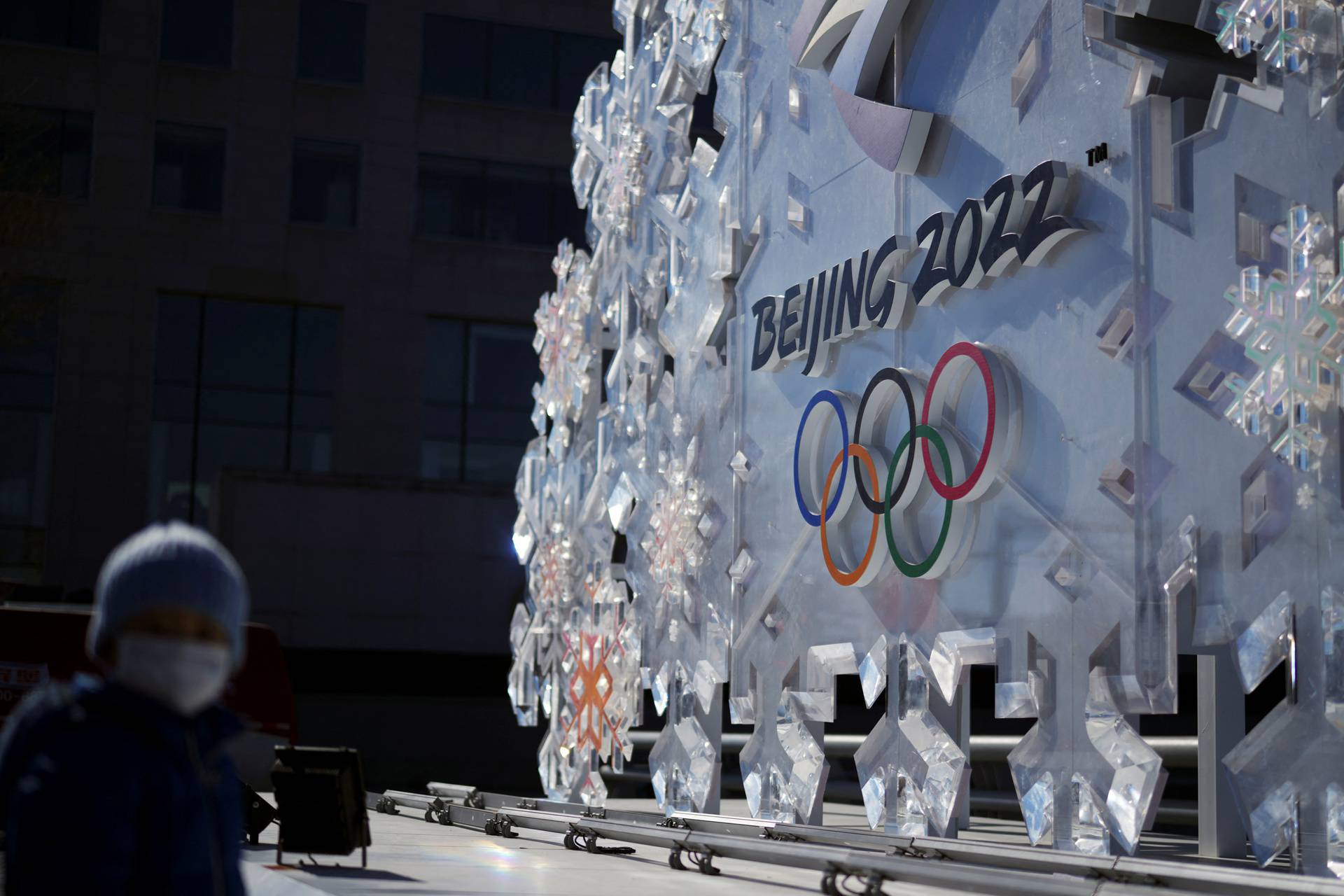 Person stands near a Beijing 2022 installation outside the closed-loop "bubble" in Beijing