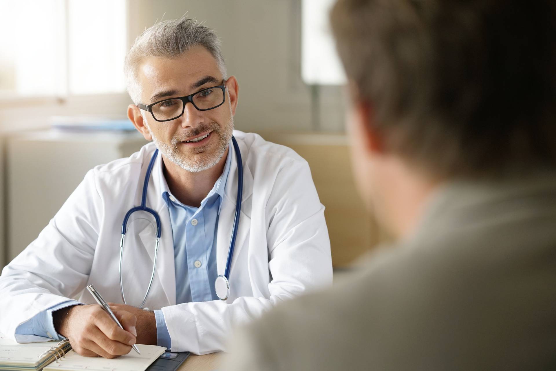 Doctor,Talking,To,Patient,In,Office