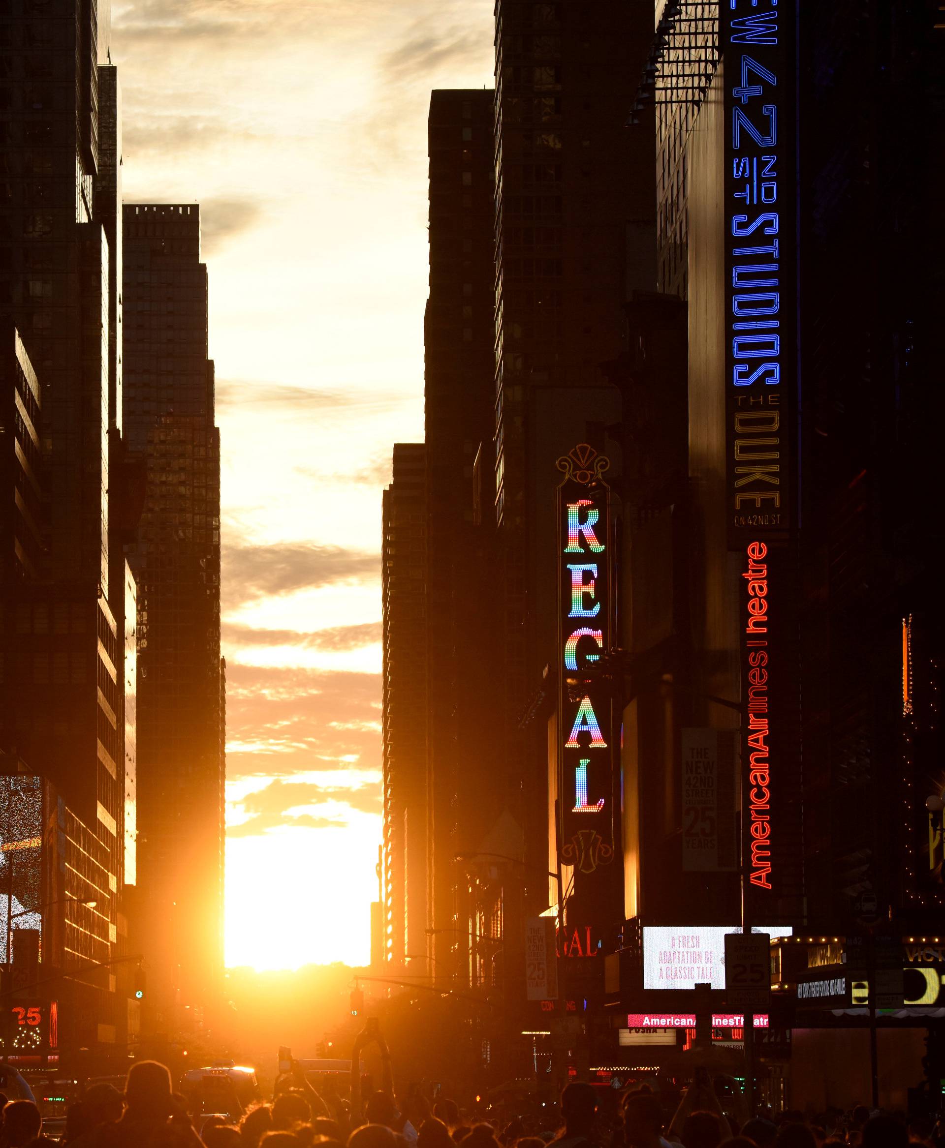 The sun sets over Manhattan, aligned exactly with the streets in a phenomenon known as "Manhattanhenge"
