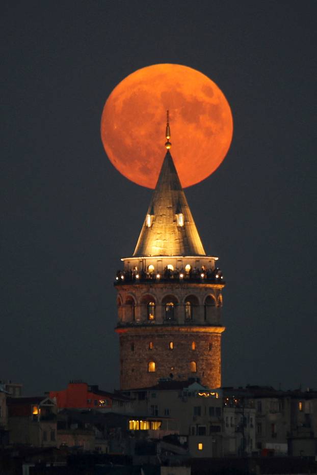 Full moon rises behind the Galata Tower in Istanbul