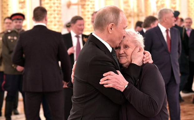 Moscow, Russia. 09th May, 2019. Russian President Vladimir Putin embraces his former school teacher, Vera Gurevich, during a reception marking the 74th anniversary of the end of World War II at the Kremlin May 9, 2019 in Moscow, Russia. Credit: Planetpix/