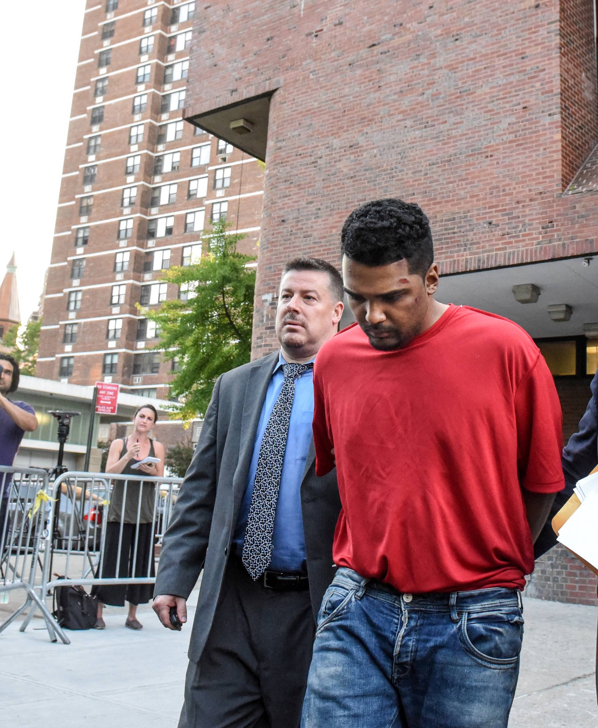 Rojas is escorted after being processed in connection with the speeding vehicle that struck pedestrians on a sidewalk in Times Square in New York City