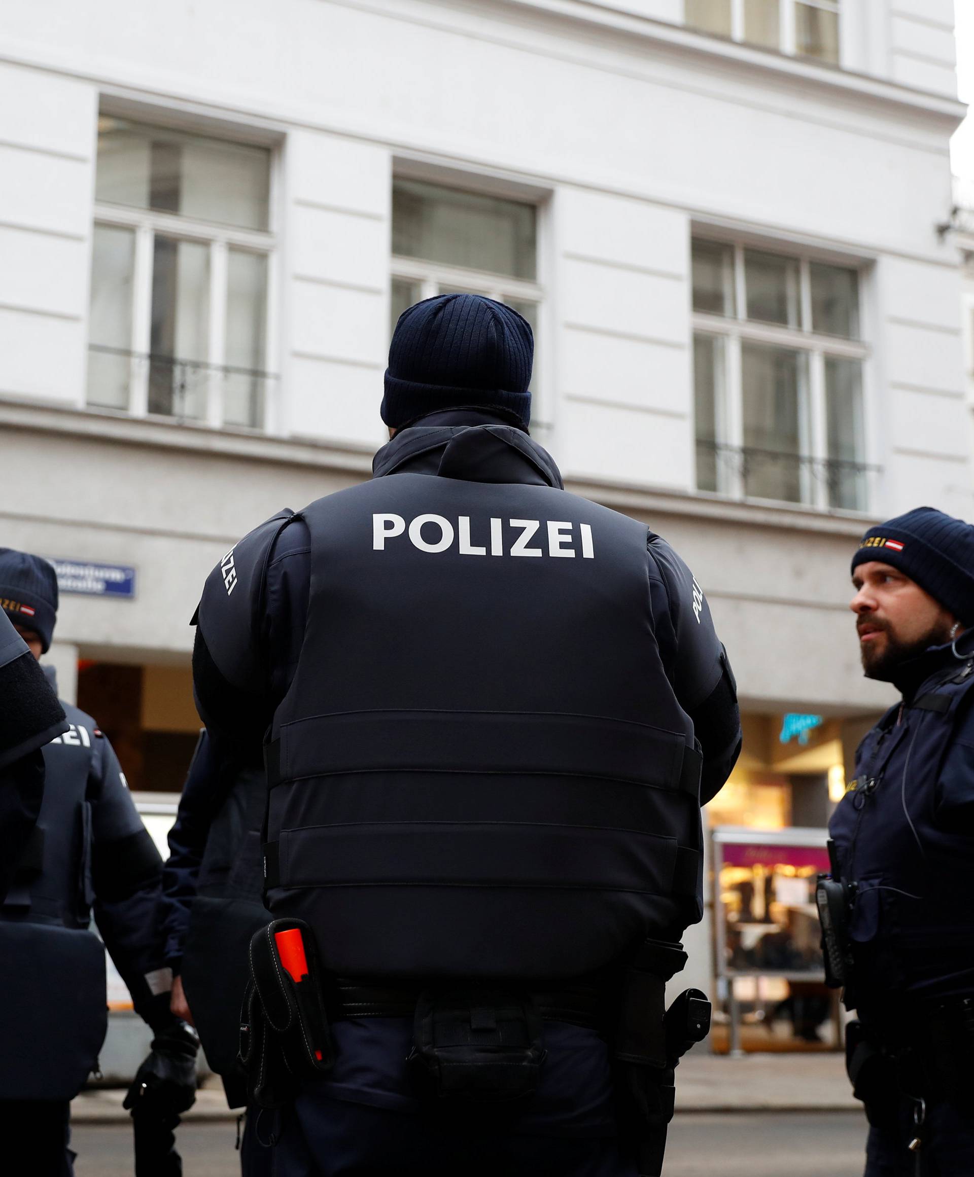 Police officers secure the area after shots were fired in a restaurant in downtown Vienna