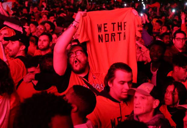 Fans celebrate their win in Game 6 of the NBA basketball Finals between the Toronto Raptors and the Golden State Warriors on a large screen in a fan zone in Montreal