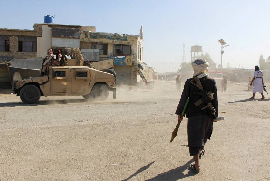 FILE PHOTO: Afghan Taliban fighters patrol near the Afghanistan-Pakistan border in Spin Boldak, Kandahar Province, following exchanges of fire between Pakistani and Afghan forces