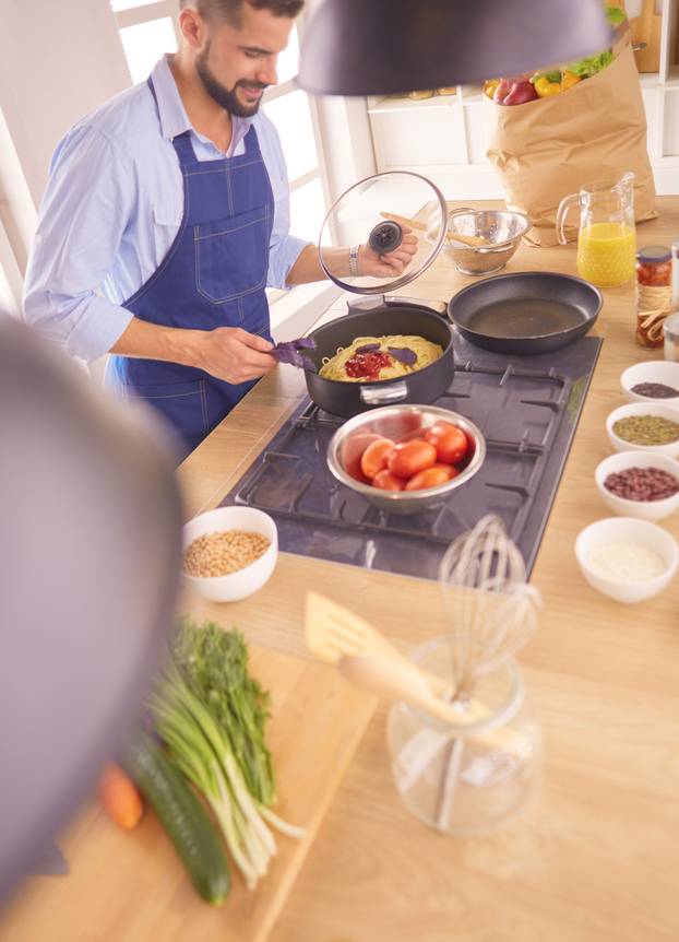 Man preparing delicious and healthy food in the home kitchen