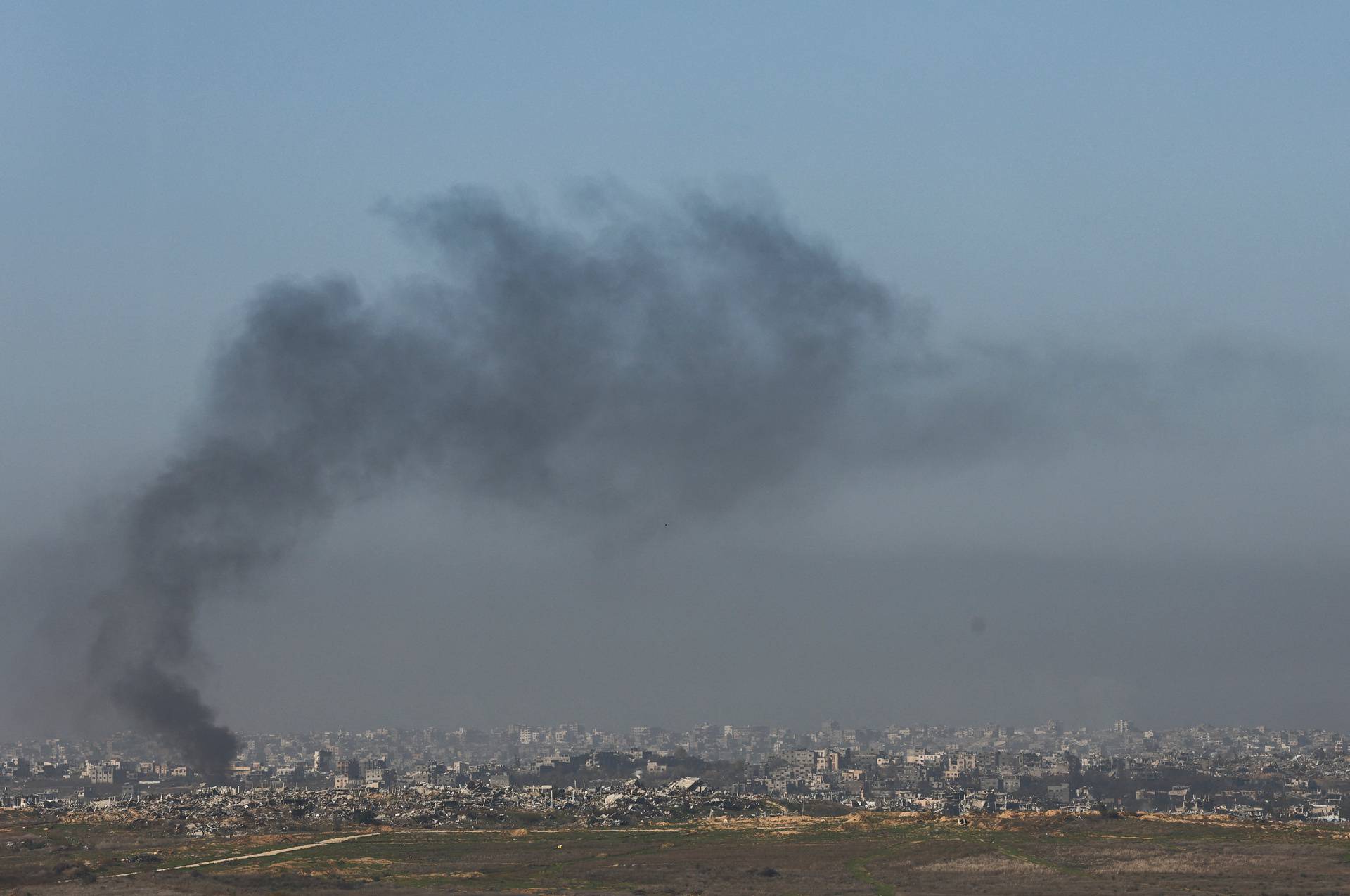 Smoke billows as buildings lie in ruin in Beit Hanoun, in the Gaza Strip, as seen from southern Israel