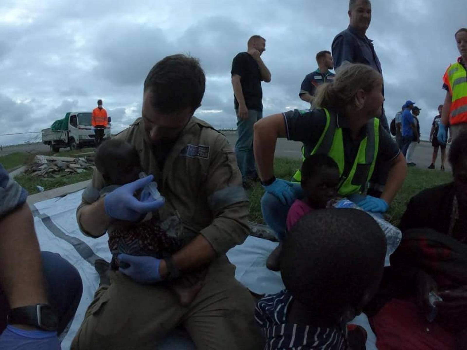 Rescue workers help affected residents after cyclone damage in Beira