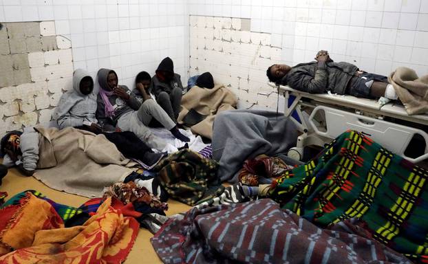 Migrants who were injured in a truck crash, are seen at a hospital in Bani Walid town