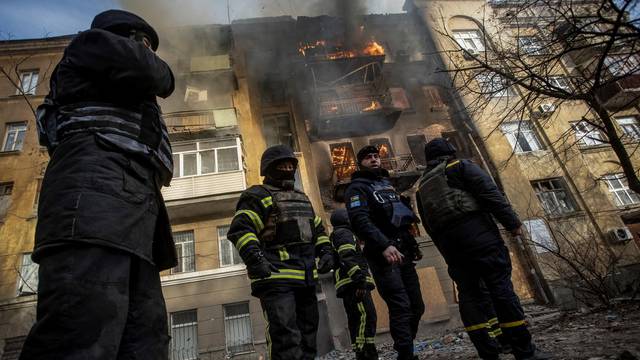 Firefighters work to put out a fire at a residential building hit by a Russian military strike in Bakhmut