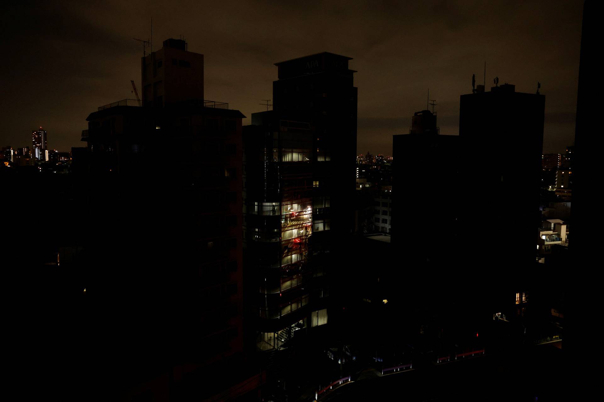 Houses and buildings are seen in an electric stoppage at the area after an earthquake at Toshima ward in Tokyo