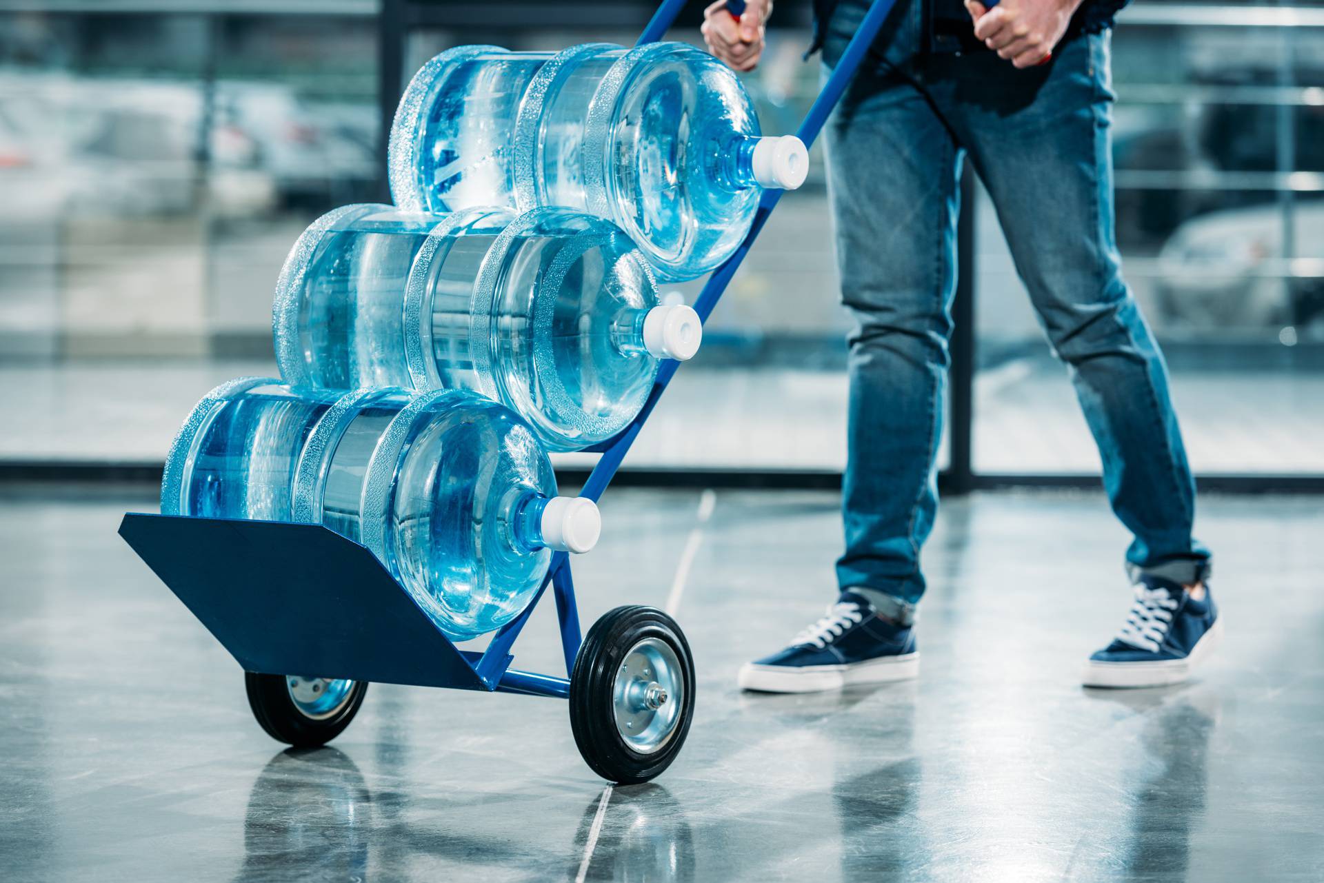 Loader pushing cart with water bottles