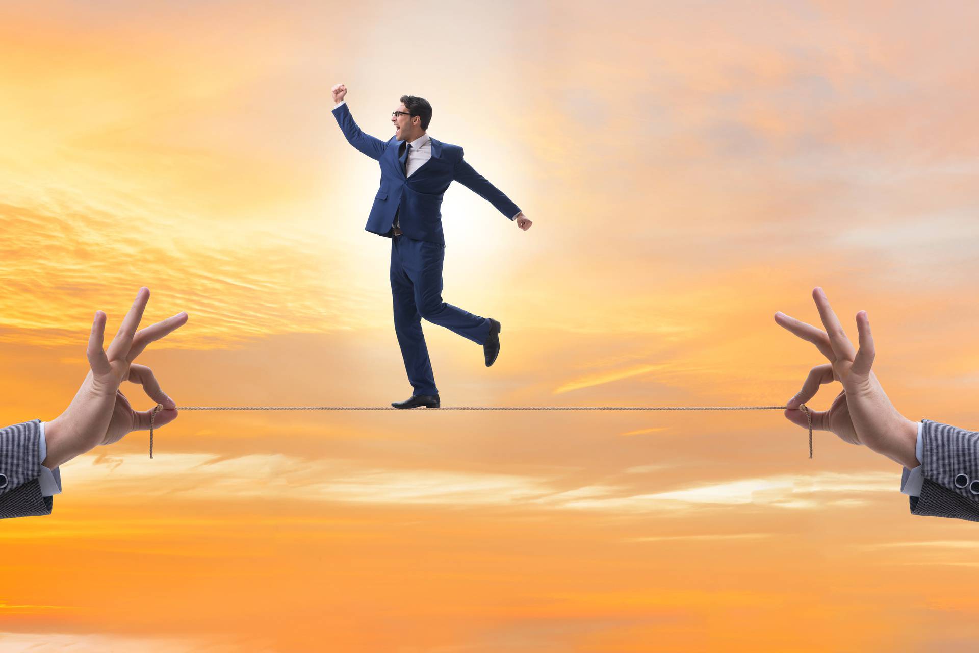 Businessman walking on tight rope