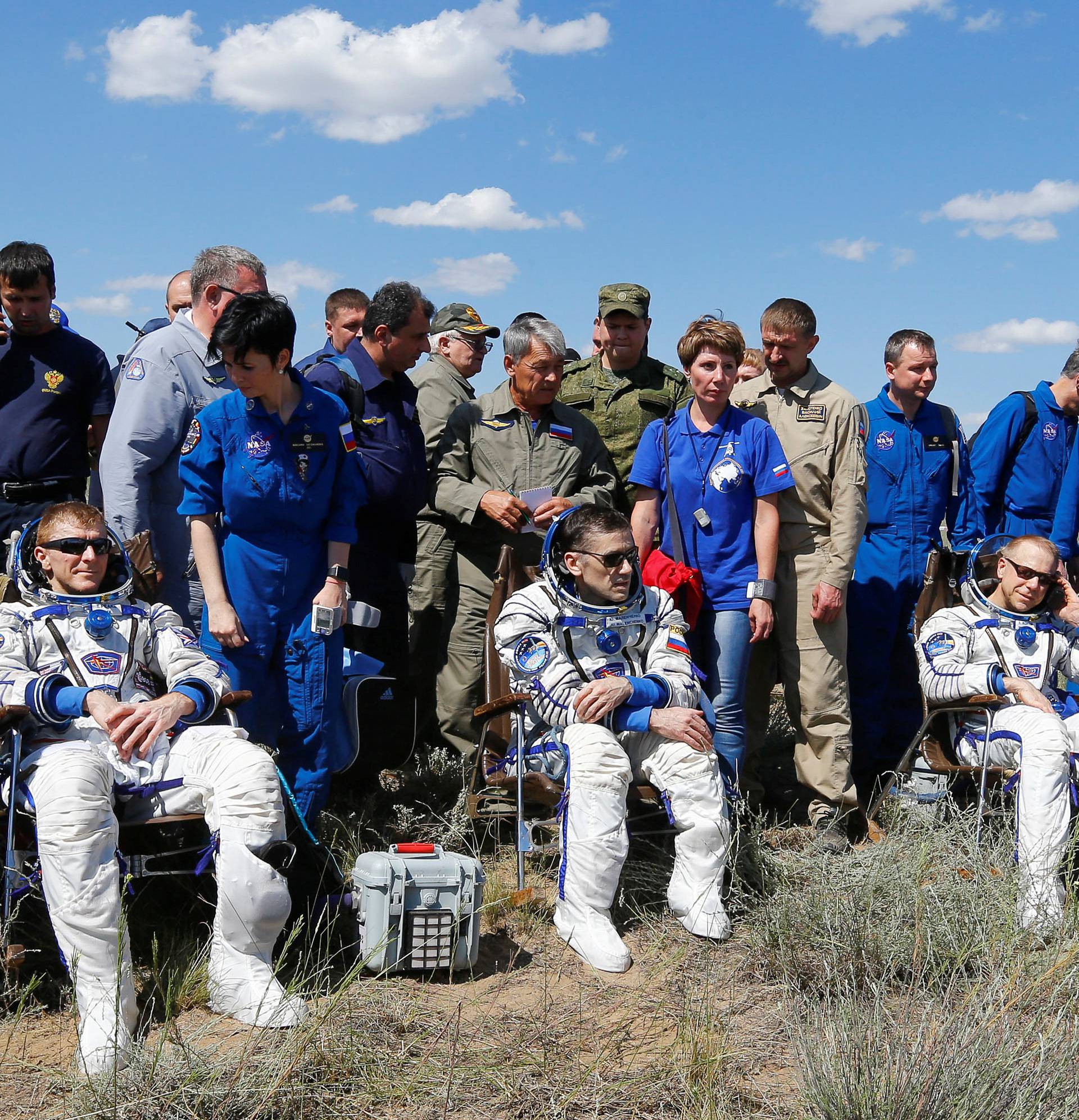 The ISS crew members Timothy Peake of Britain, Yuri Malenchenko of Russia and Timothy Kopra of the U.S. rest shortly after landing near Dzhezkazgan