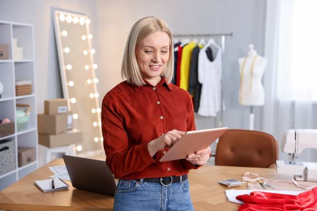 Business,Owner,With,Tablet,In,Her,Tailor,Shop