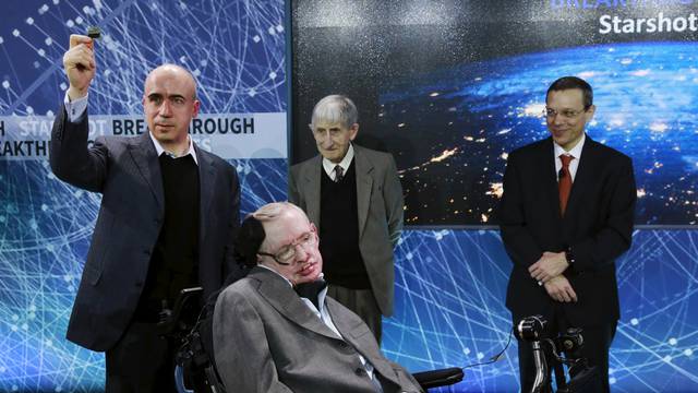 Physicist Stephen Hawking sits in front of  investor Yuri Milner (L), physicist Freeman Dyson (C), and physicist Avi Loeb on stage during an announcement of the Breakthrough Starshot initiative in New York
