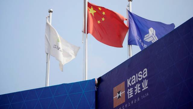 FILE PHOTO: A Kaisa sign is seen in front a Chinese flag at a construction site being developed by Kaisa Group Holdings