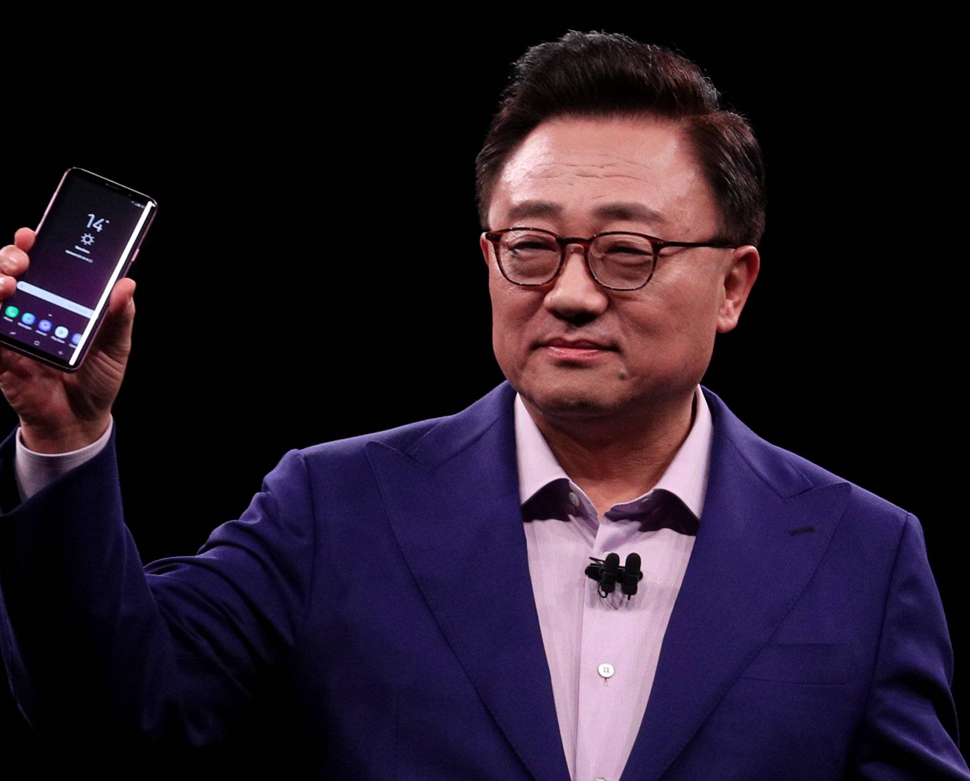 DJ Koh, Samsung's Mobile Communications Business president, holds up new S9Plus devicesduring presentation ceremony in Barcelona