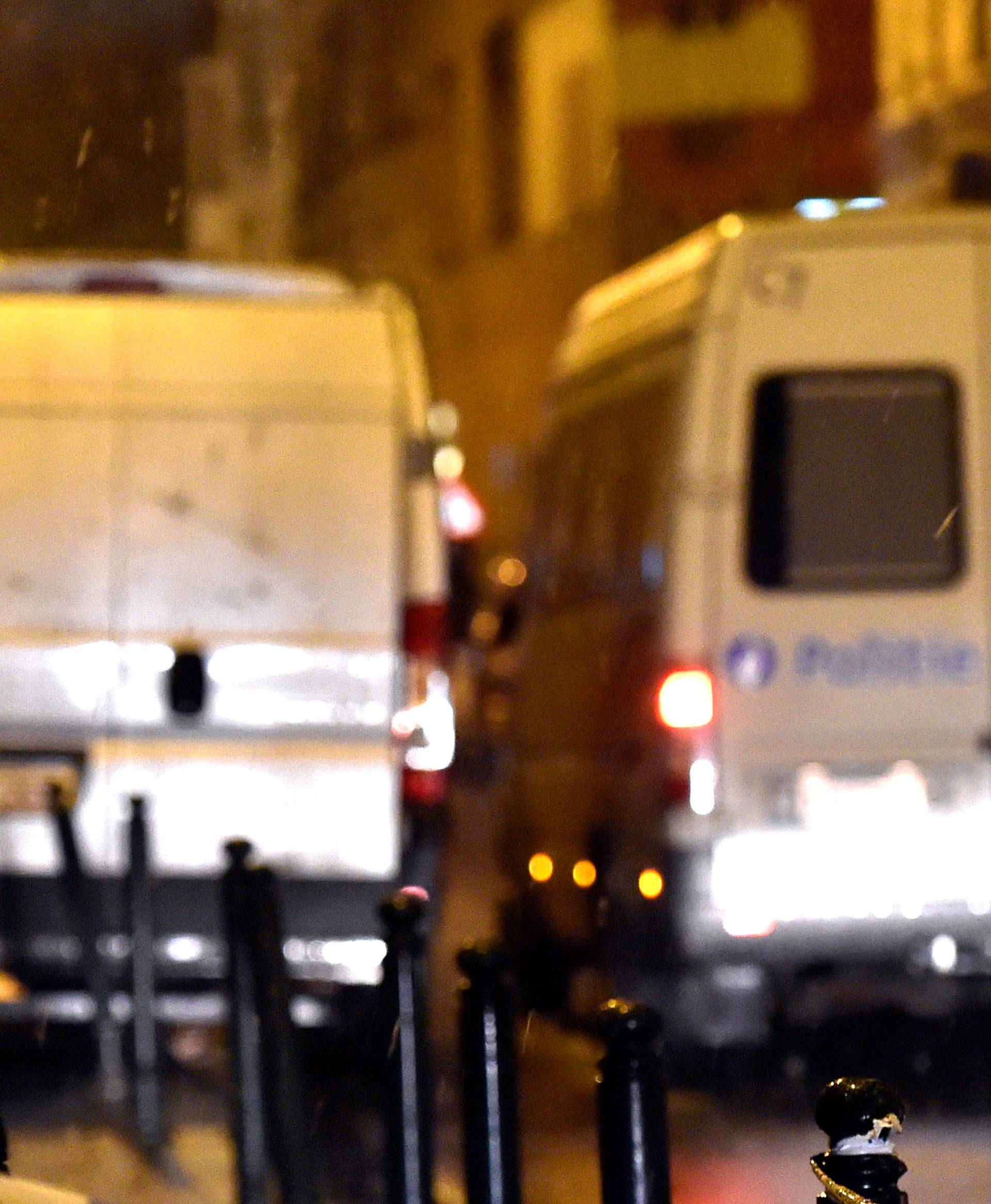 Belgian police officers stand guard at the scene of a security operation in the Brussels district of Molenbeek