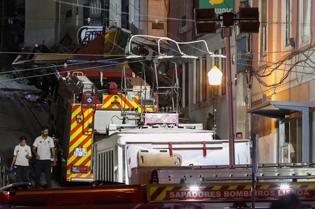 First responders work at the site of a funicular accident in Lisbon