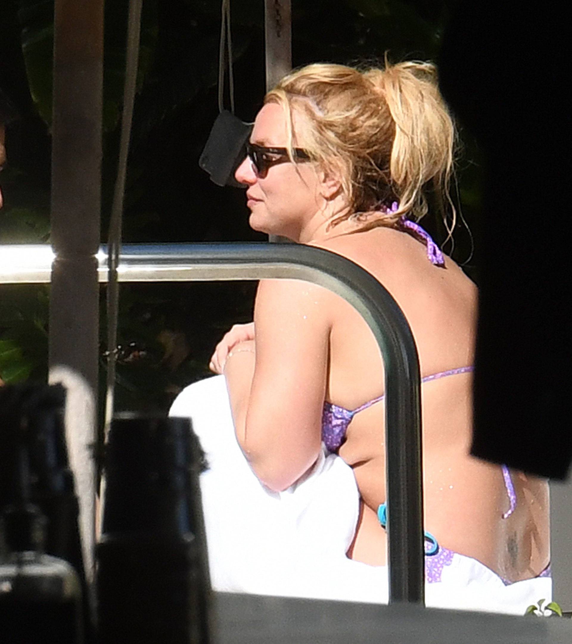 *PREMIUM EXCLUSIVE* Britney Spears takes a dip in the pool after arriving in Miami to celebrate her 38th birthday.