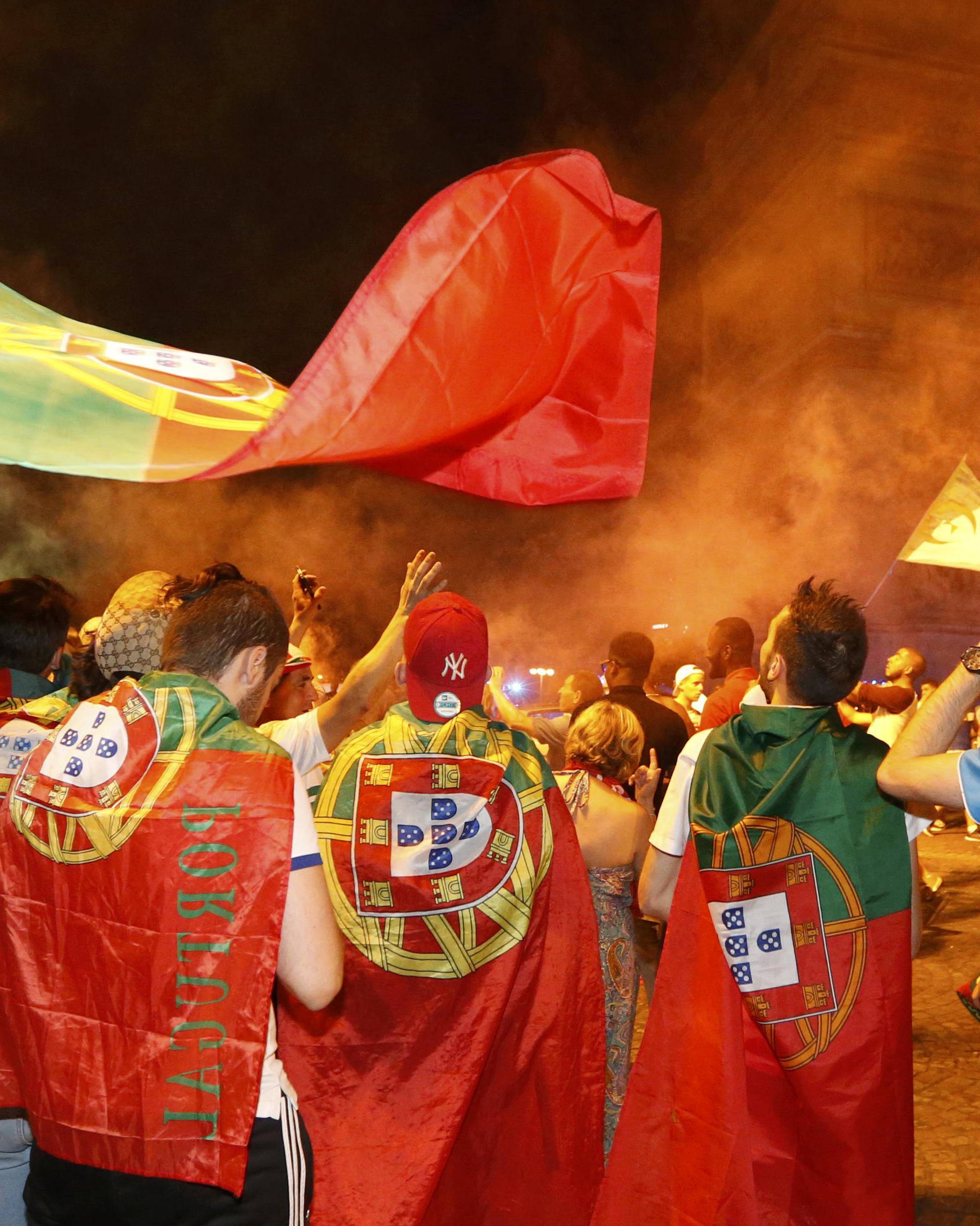 Portugal fans react on the Champs-Elysees after their team won the EURO 2016 final soccer match       