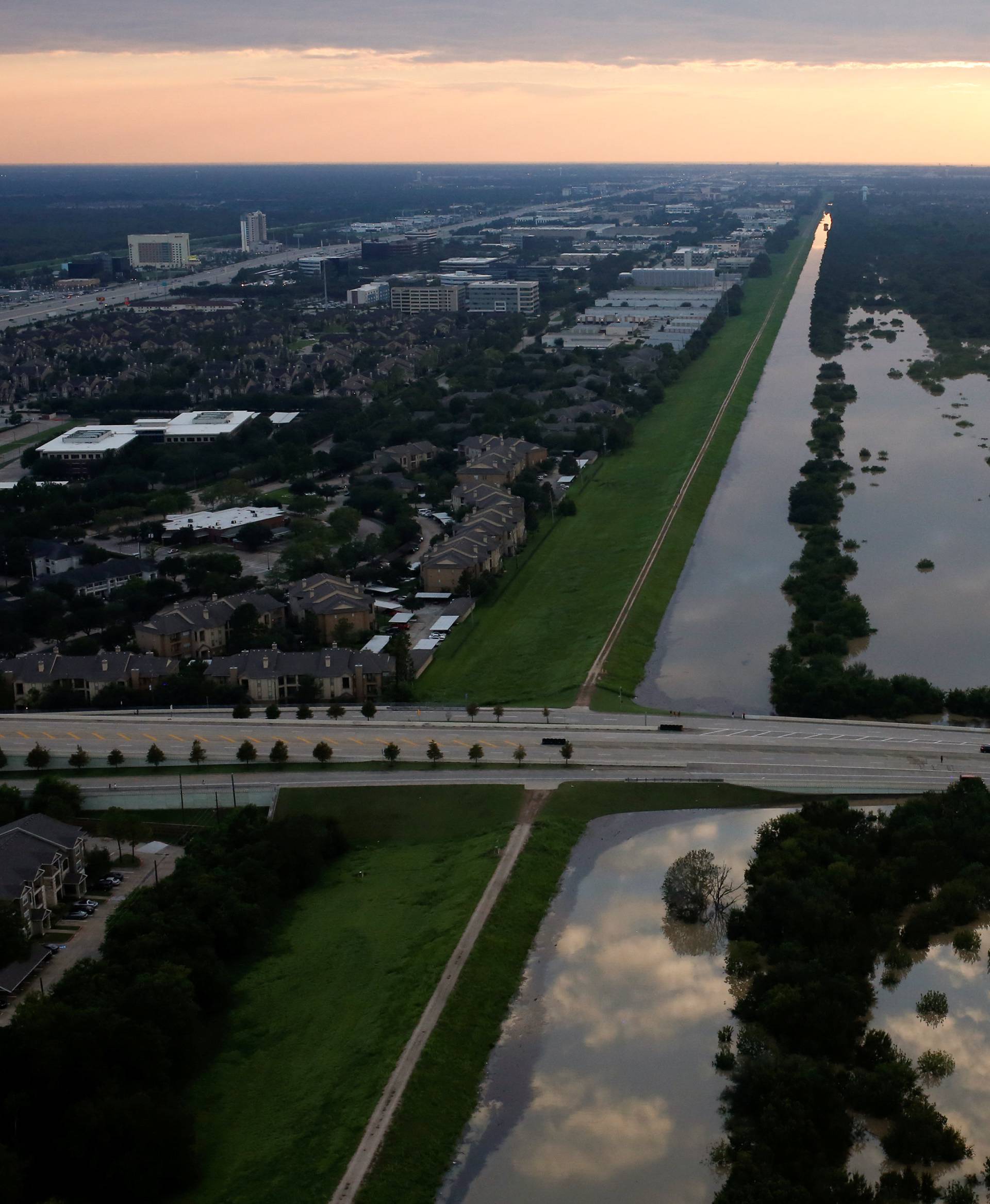 The Addicks reservoir is seen to the right full of rain water brought by Tropical Storm Harvey in West Houston