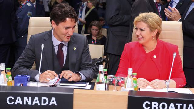 Canada's Prime Minister Trudeau talks to Croatia's President Grabar-Kitarovic during a session at the NATO Summit in Warsaw