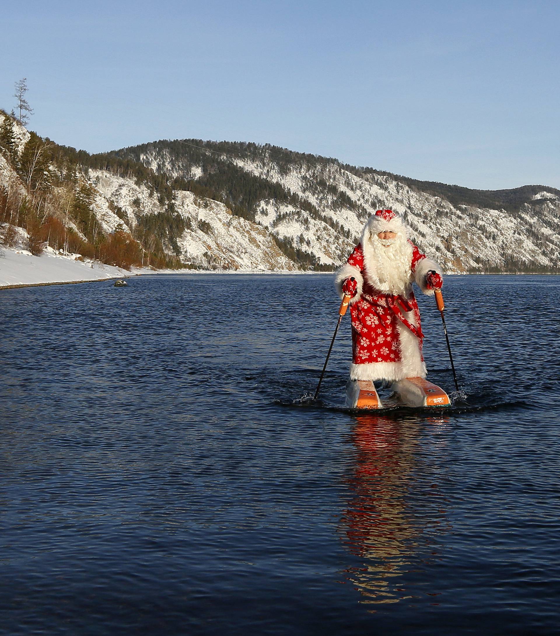 Nikolai Vasilyev, dressed as Father Frost, water-skis along the Yenisei River outside Krasnoyarsk