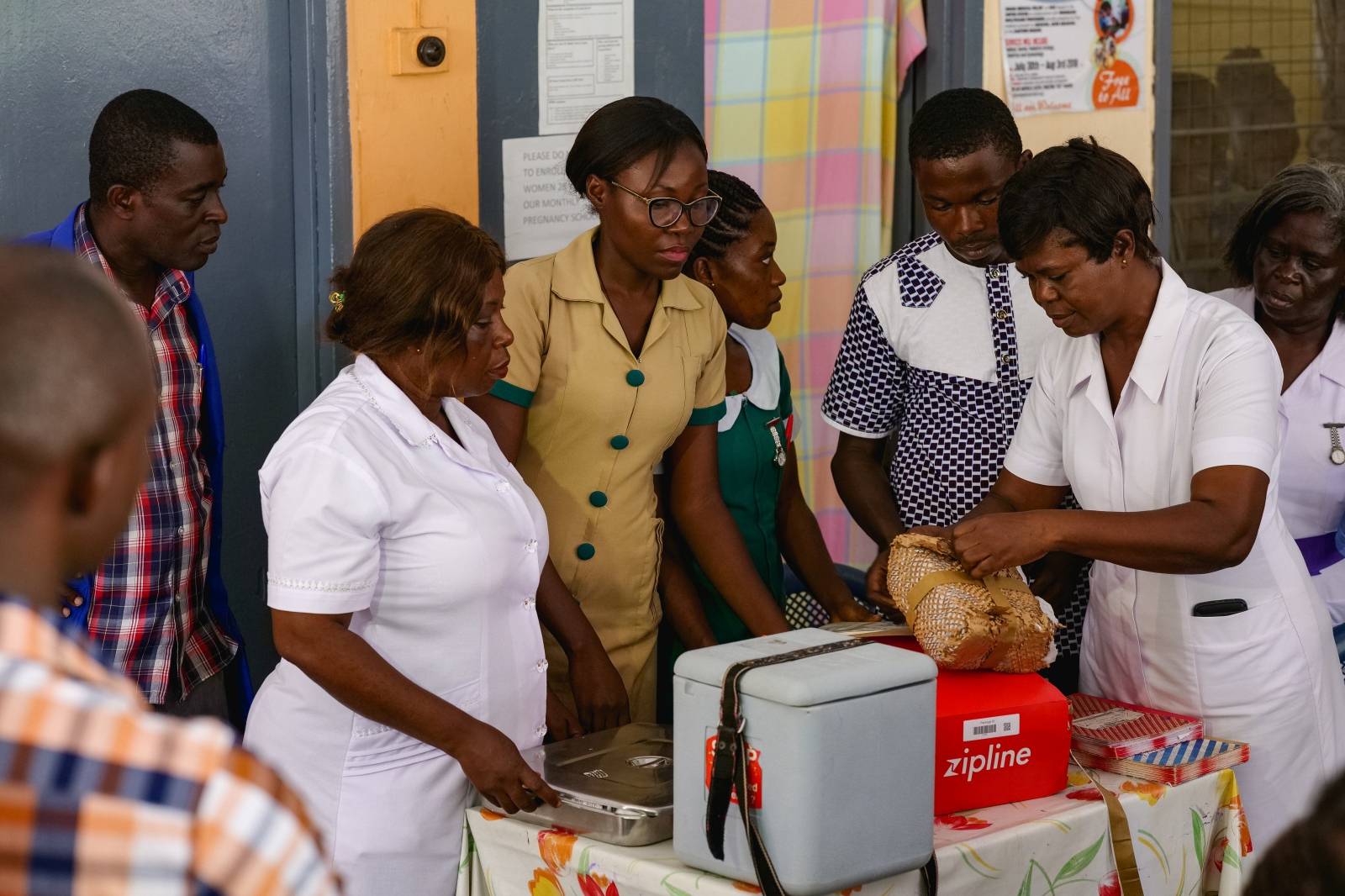 A nurse unpacks a Zipline vaccine delivery in Ghana