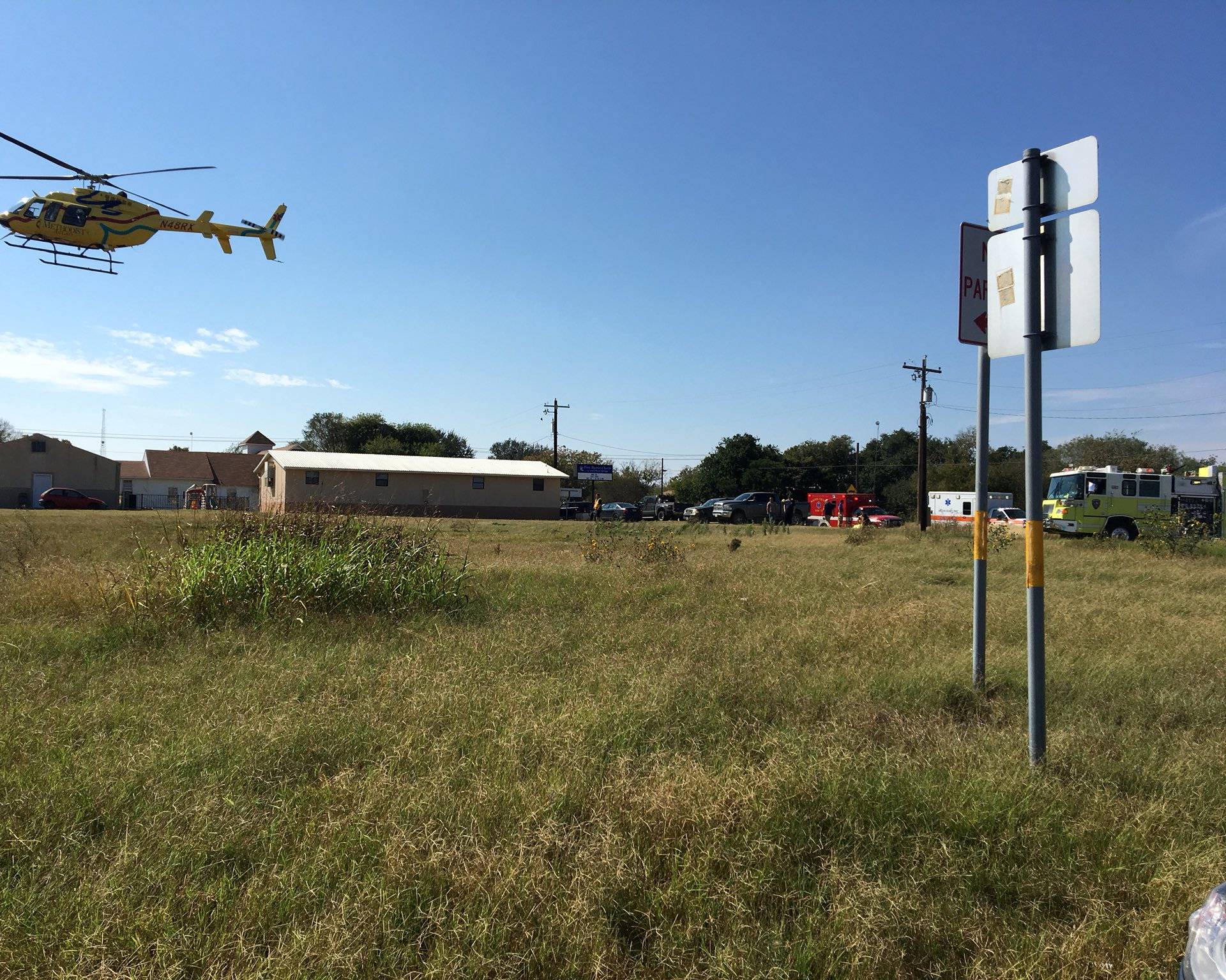 A helicopter flies near the site of a mass shooting in Sutherland Springs