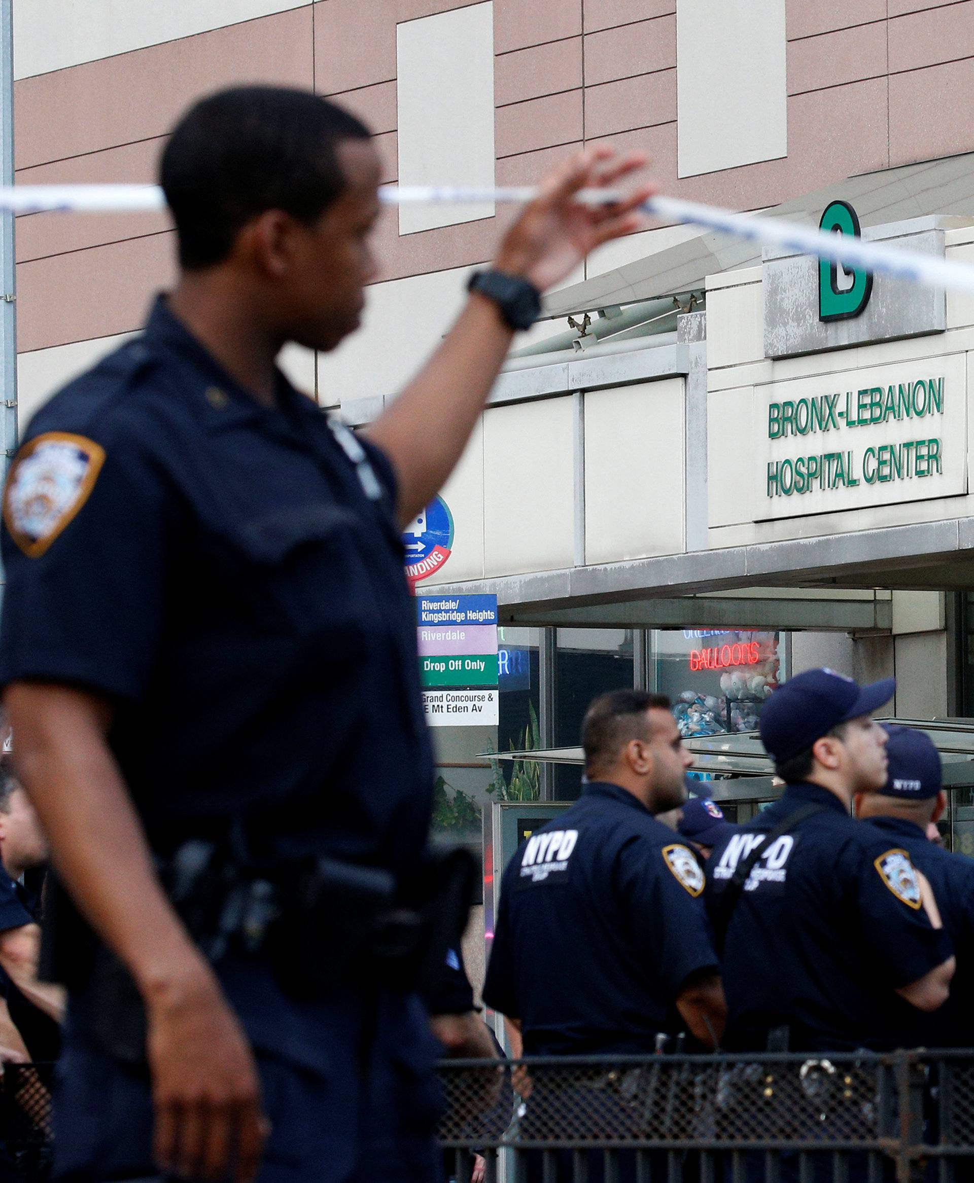 NYPD officers work outside Bronx-Lebanon Hospital, after an incident in which a gunman fired shots inside the hospital in New York