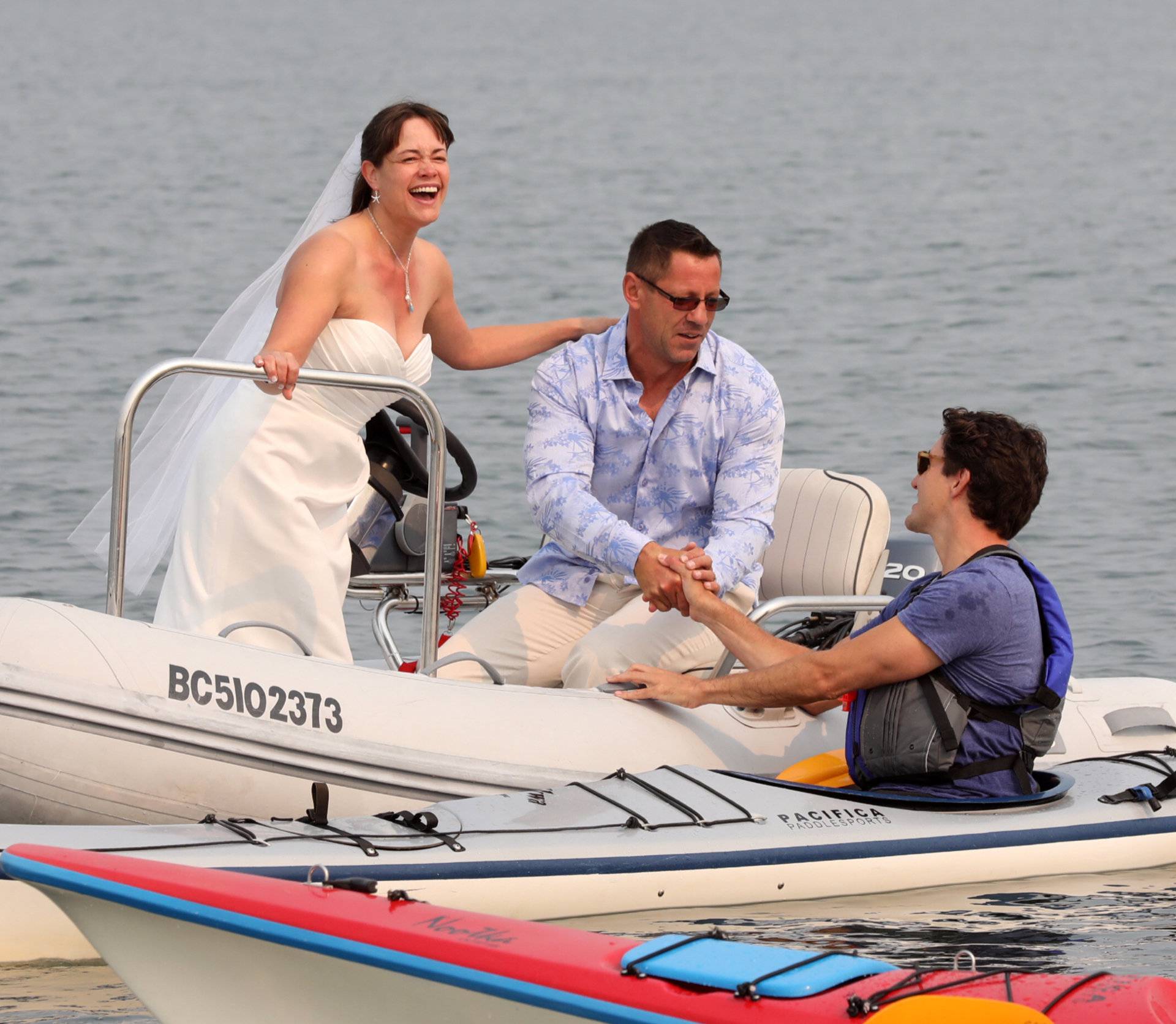 Newlyweds Michelle and Heiner Gruetzner approach Canada's Prime Minister Justin Trudeau while he was kayaking off Sidney