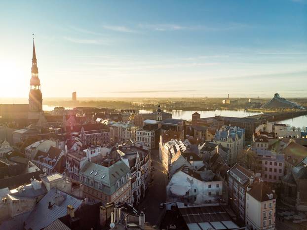 Beautiful Riga city panorama in winter with snow covered houses, churches and streets. Aerial view. Winter city scenery in Riga, Latvia.
