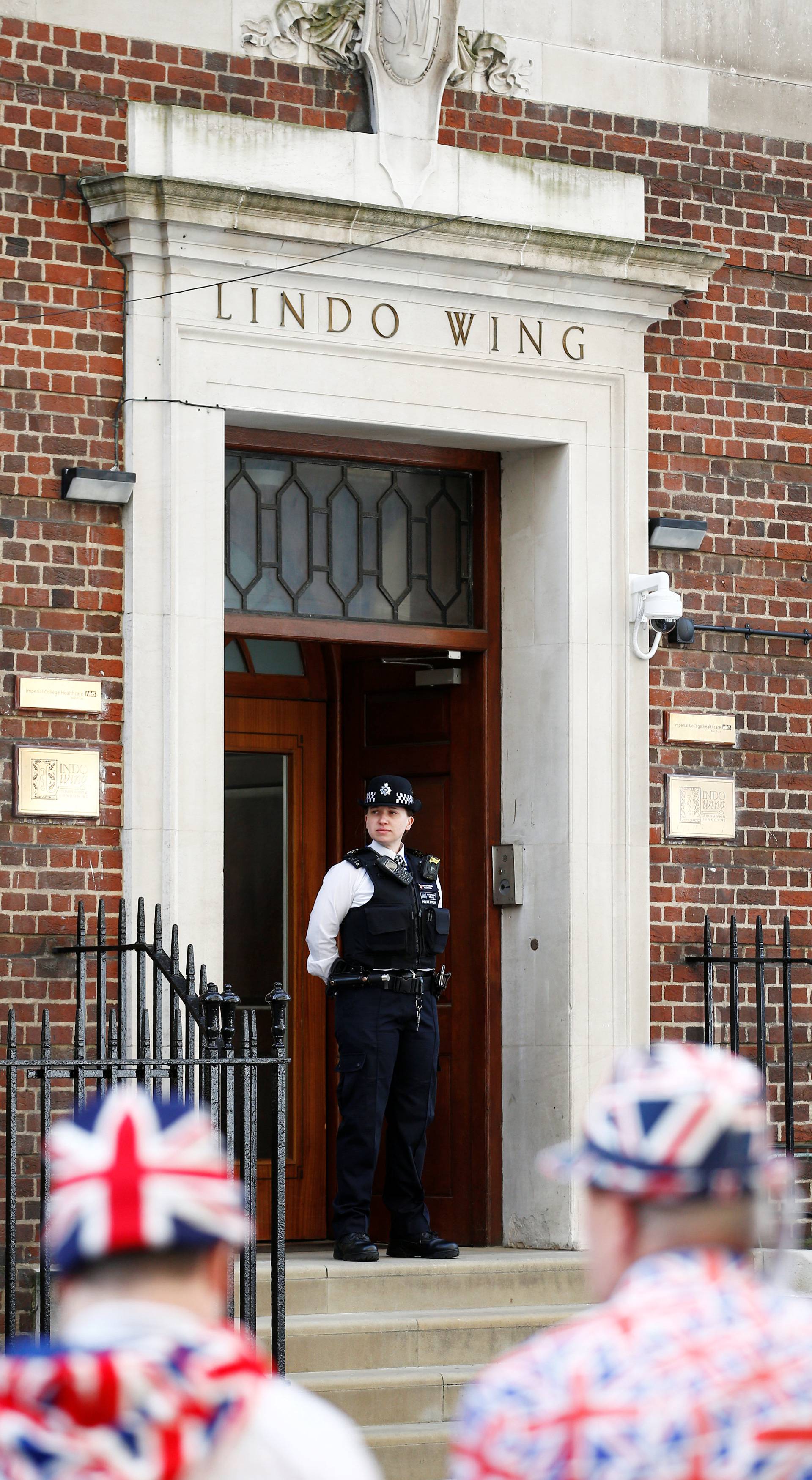 Supporters of the royal family stand outside the Lindo Wing of St Mary's Hospital after Britain's Catherine, the Duchess of Cambridge, was admitted after going into labour ahead of the birth of her third child, in London