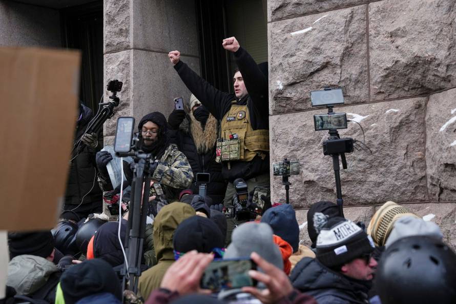 People attend the "March Against Minnesota Fraud" in Minneapolis