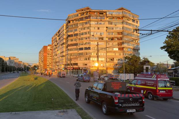 Firefighters and law enforcement work on the site of an explosion at a residential block of flats following a drone hit close to the border with Ukraine