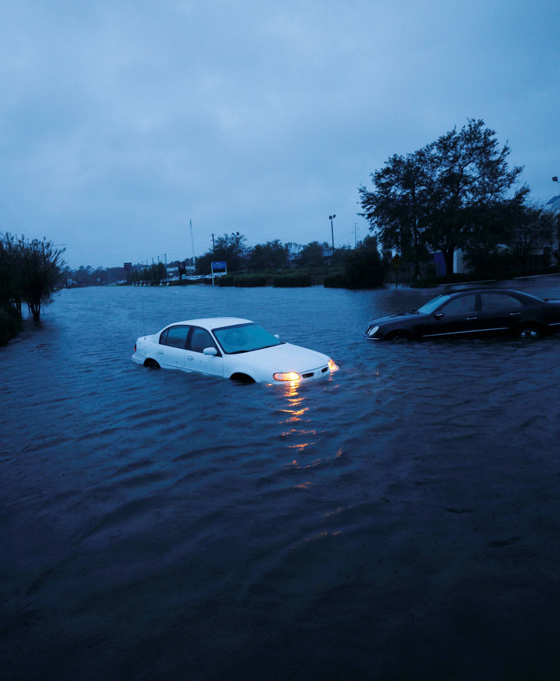 An abandoned car's hazard lights continue to flash as it sits submerged in a rising flood waters after Hurricane Florence struck in Wilmington, North Carolina