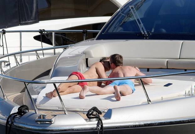 Neil Patrick and Harris David Burtka share a passionate kiss while enjoying the sun on a luxury yacht in Saint Tropez