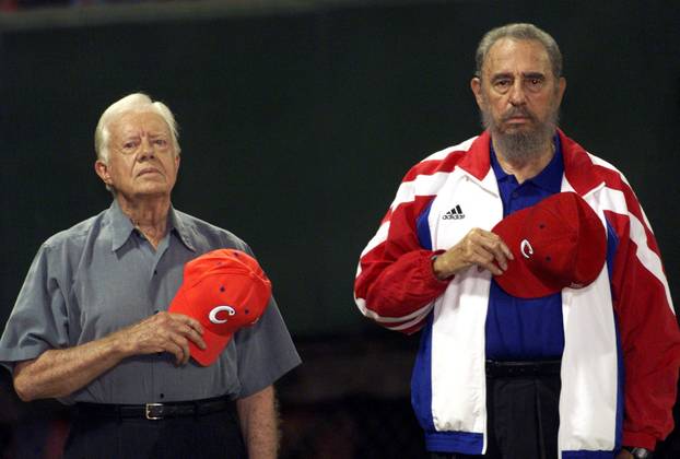 FILE PHOTO: Former U.S. President Jimmy Carter and Cuban President Fidel Castro listen to the Cuban national anthem at the baseball stadium "Latinoamericano" in Havana