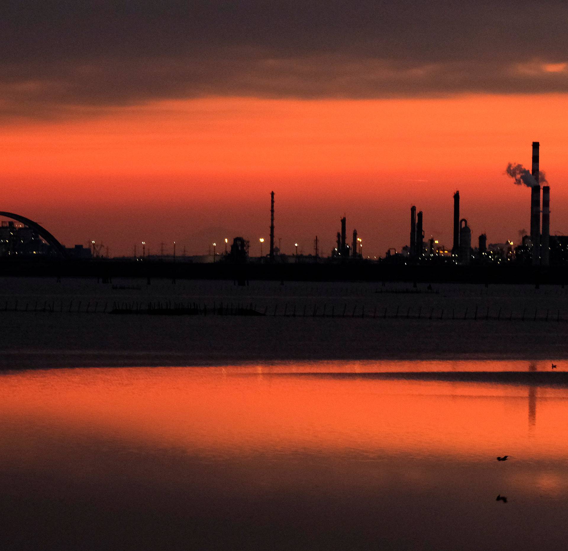 Docks are seen at sunset at the Industrial port of Marghera in the lagoon of Venice