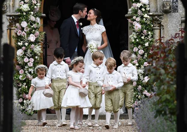 Pippa Middleton kisses her new husband James Matthews, following their wedding ceremony at St Mark