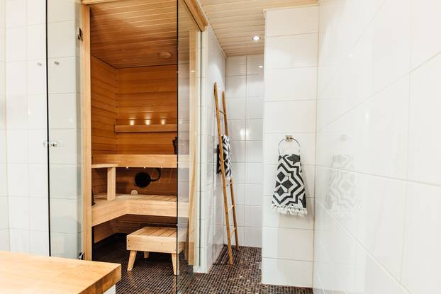 Finnish,Bathroom,With,A,Small,Wooden,Sauna,And,Mosaic,Tile