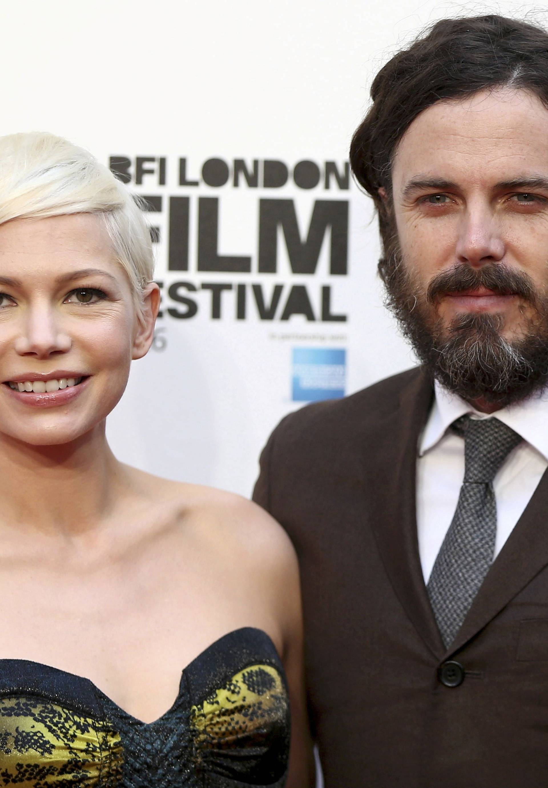 Actors Michelle Williams and Casey Affleck pose for photographers at a Gala screening of their film "Manchester by the Sea" at the 60th BFI London Film Festival in London