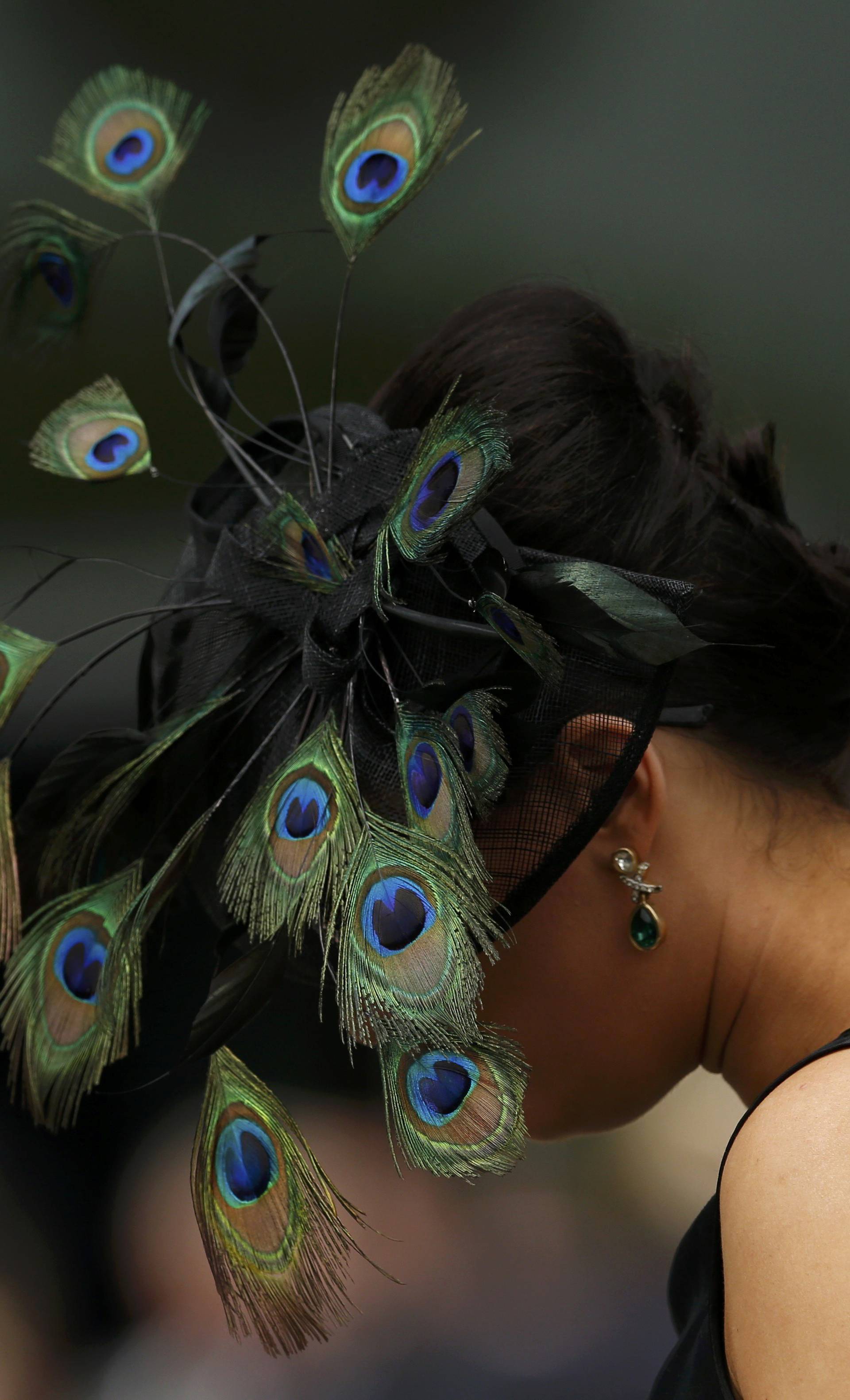 Britain Horse Racing Ladies Day Racegoer wears hat