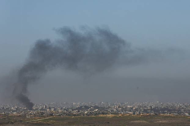 Smoke billows as buildings lie in ruin in Beit Hanoun, in the Gaza Strip, as seen from southern Israel