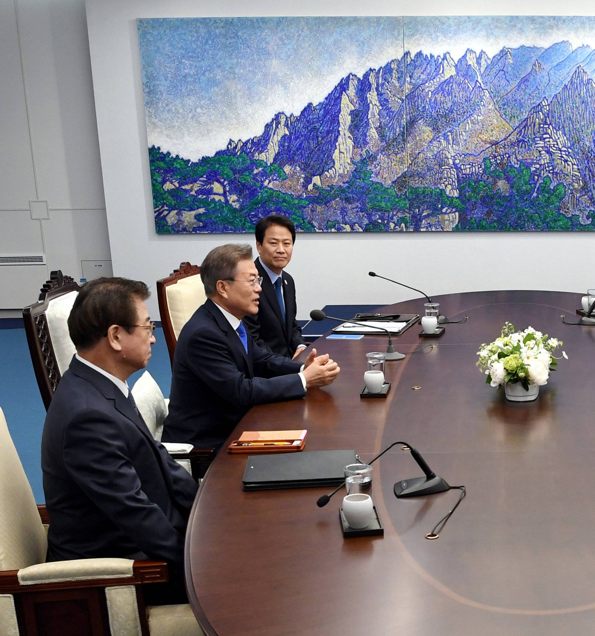 South Korean President Moon Jae-in talks with North Korean leader Kim Jong Un during their meeting at the Peace House