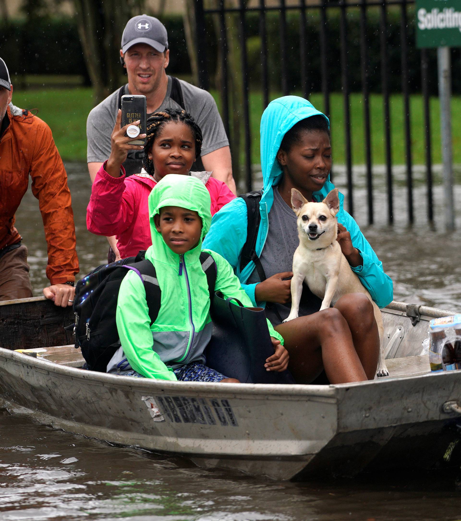 A family is evacuated by boat from the Hurricane Harvey floodwaters in Houston