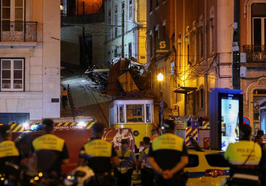 First responders work at the site of a funicular accident in Lisbon